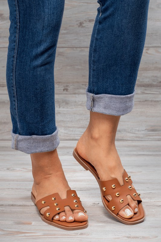 Tan studded brown flip flops